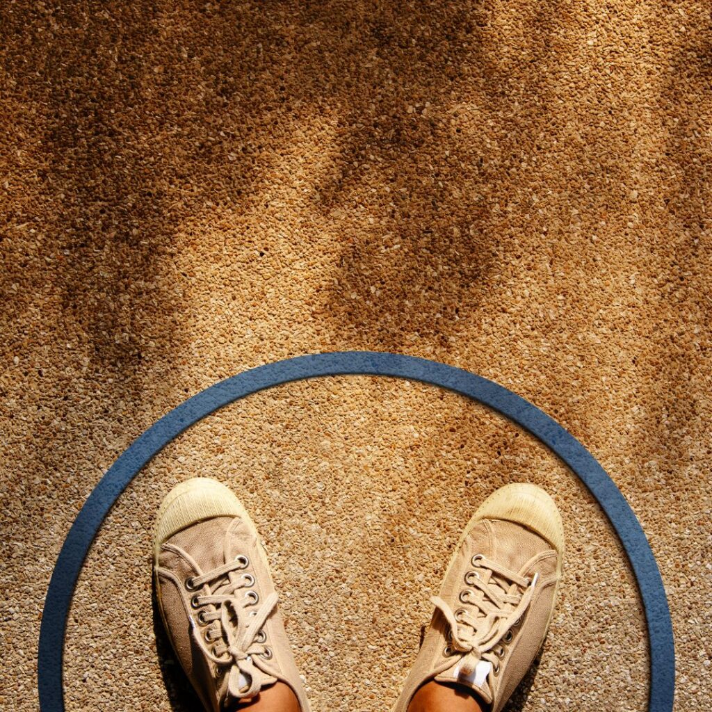 person stands confined inside a circle on the ground