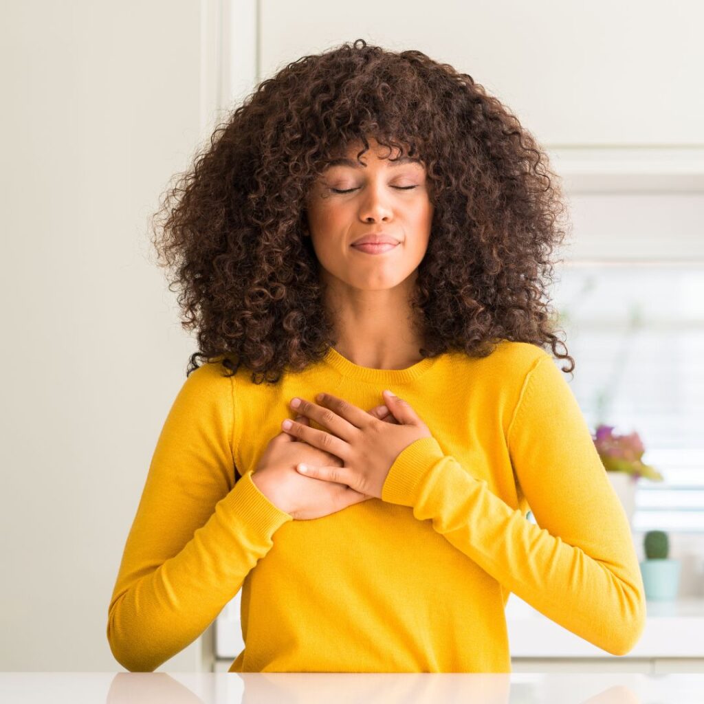 Women grabbing her chest in gratitude