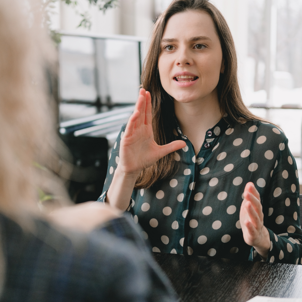 Women speaking to another women